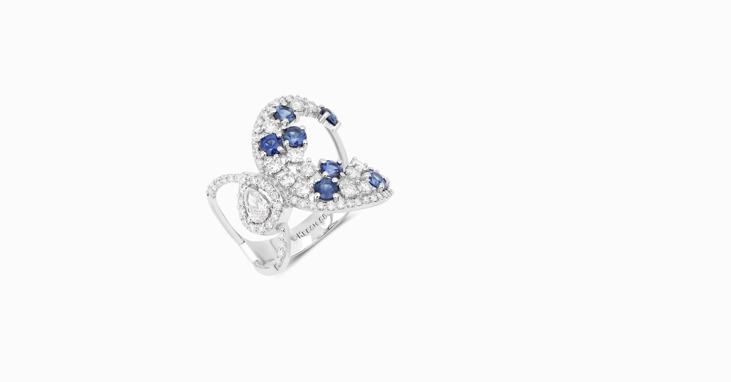 14kt white gold ring with round and pear-shaped diamonds and round-shaped blue sapphire
