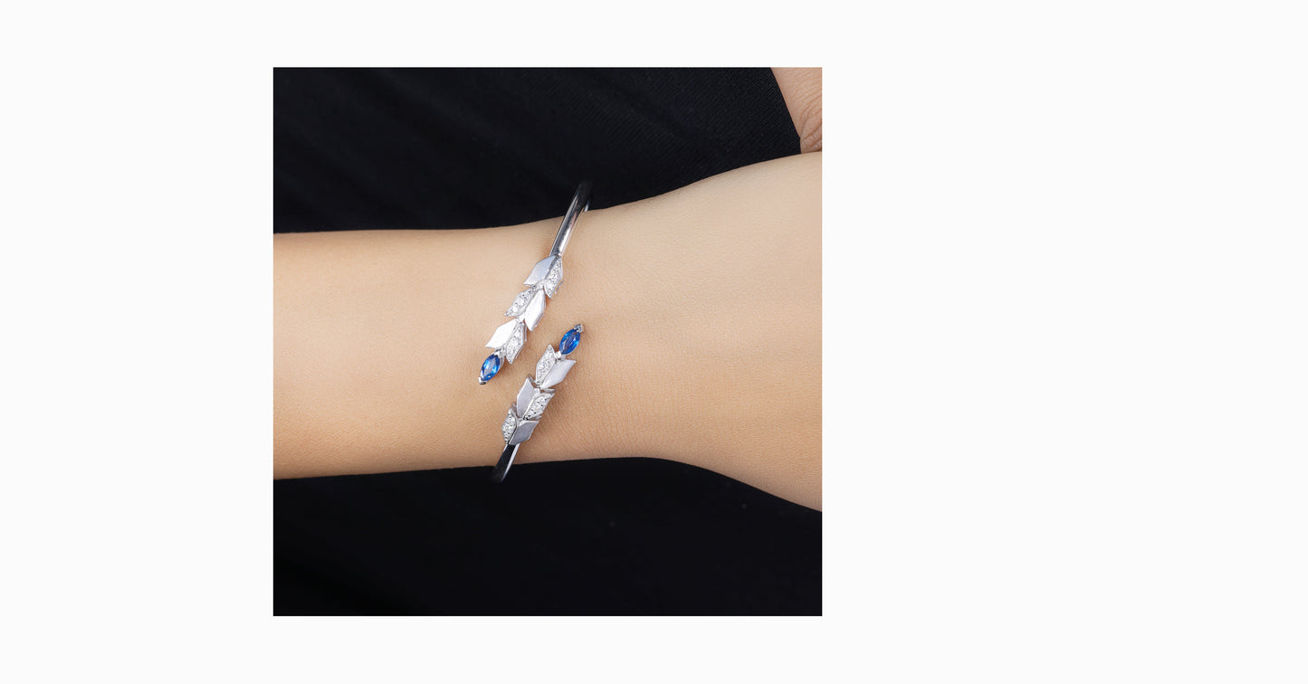 14kt white gold bangle with marquise-shaped sapphire and pave diamonds