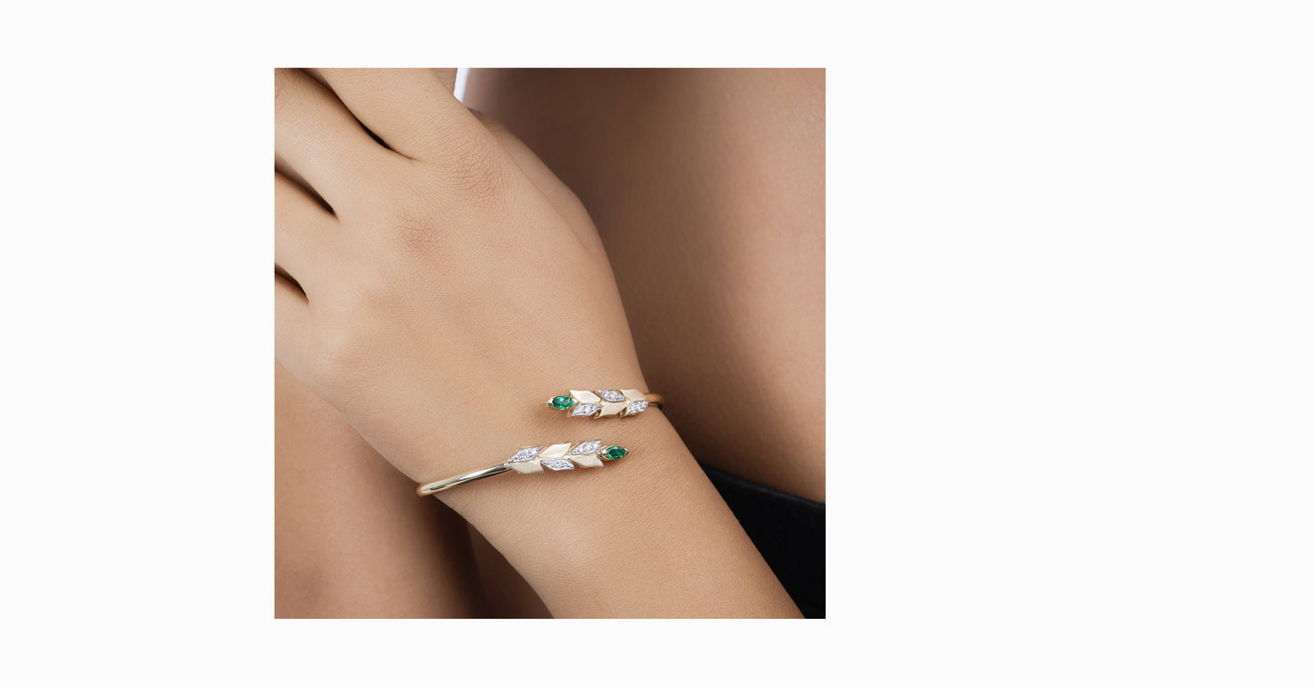14kt yellow gold bangle with marquise-shaped emerald and pave diamonds