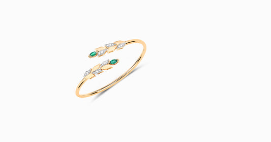 14kt yellow gold bangle with marquise-shaped emerald and pave diamonds
