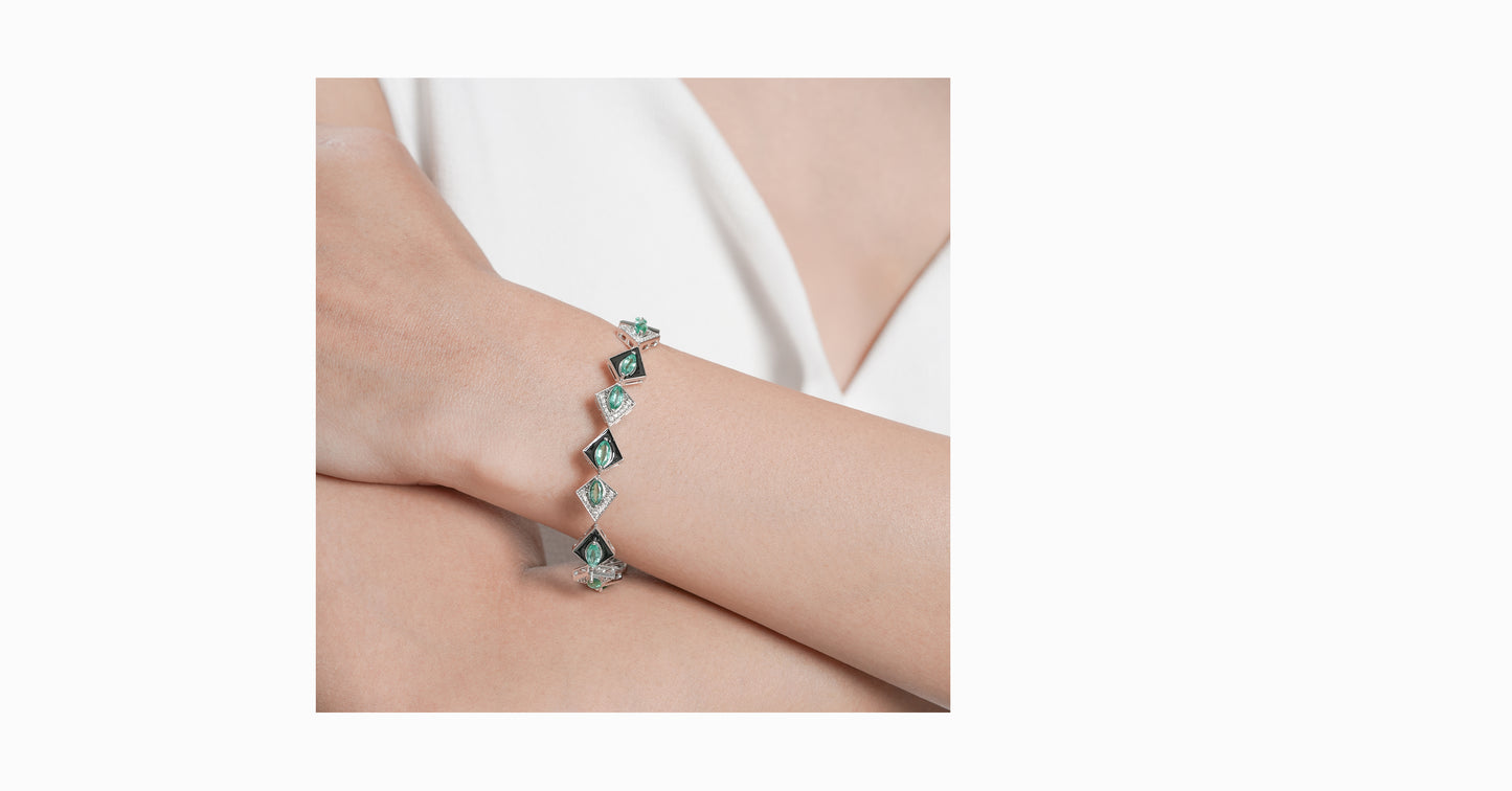 14kt white gold bracelet with round-shaped diamonds and marquise-shaped emerald