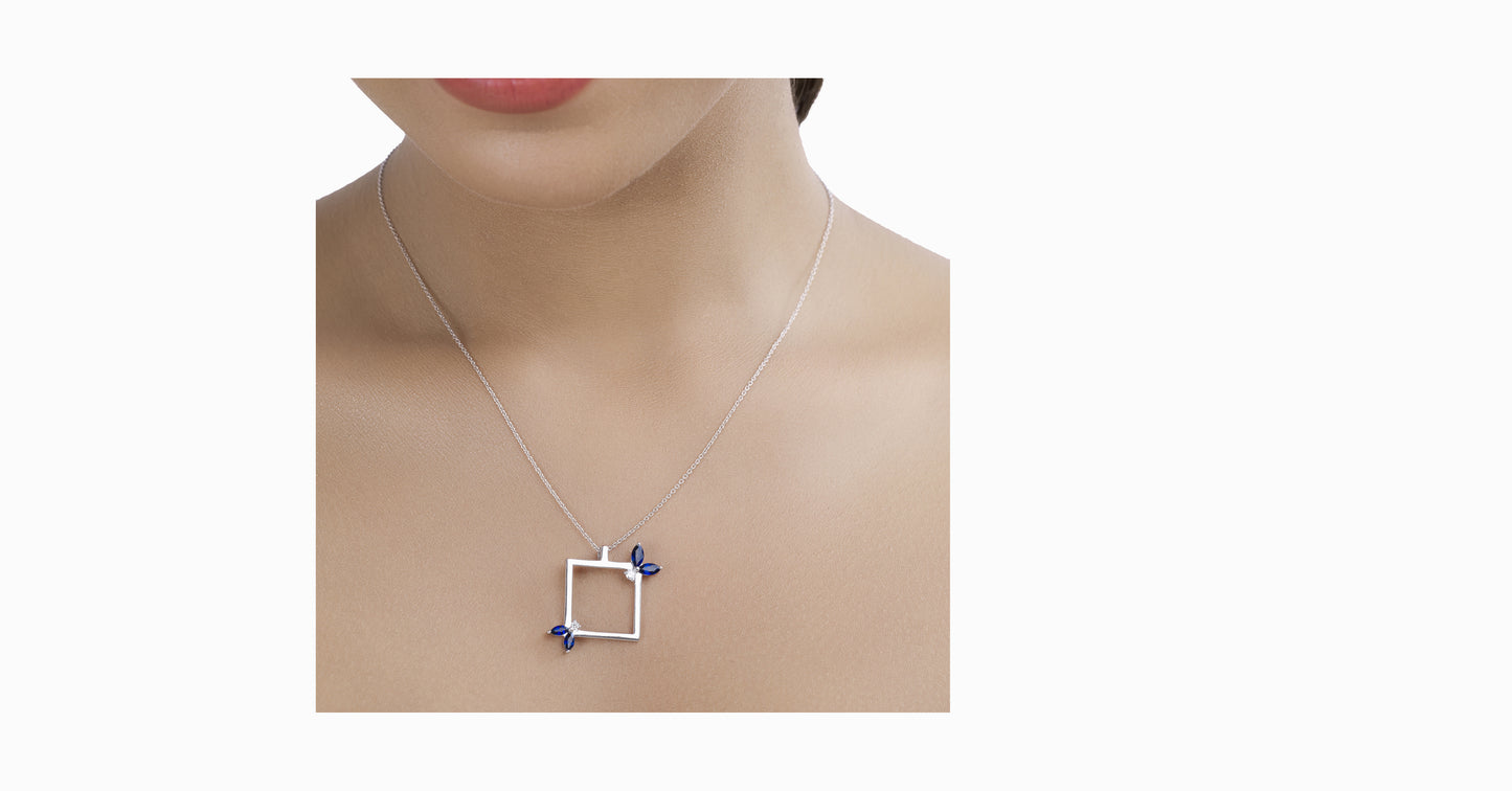 14kt white gold pendant with marquise-shaped blue sapphire and diamonds