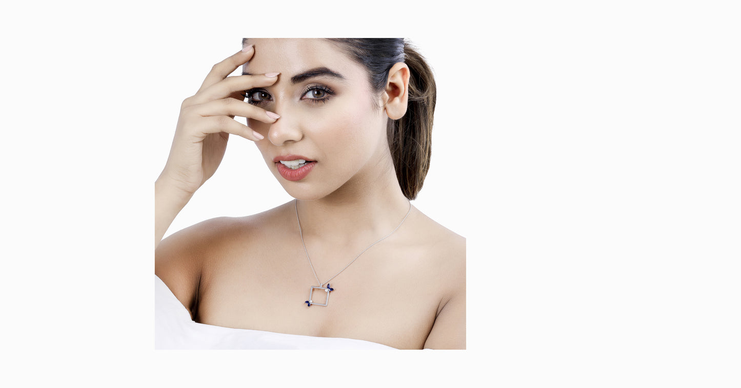 14kt white gold pendant with marquise-shaped blue sapphire and diamonds