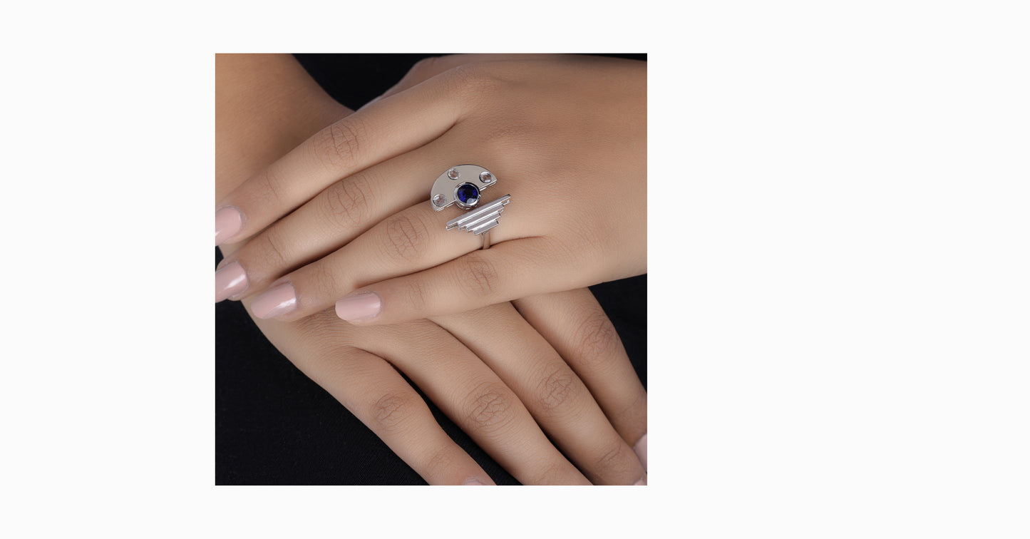 14kt white gold ring with round-shaped blue sapphire and bezel diamonds