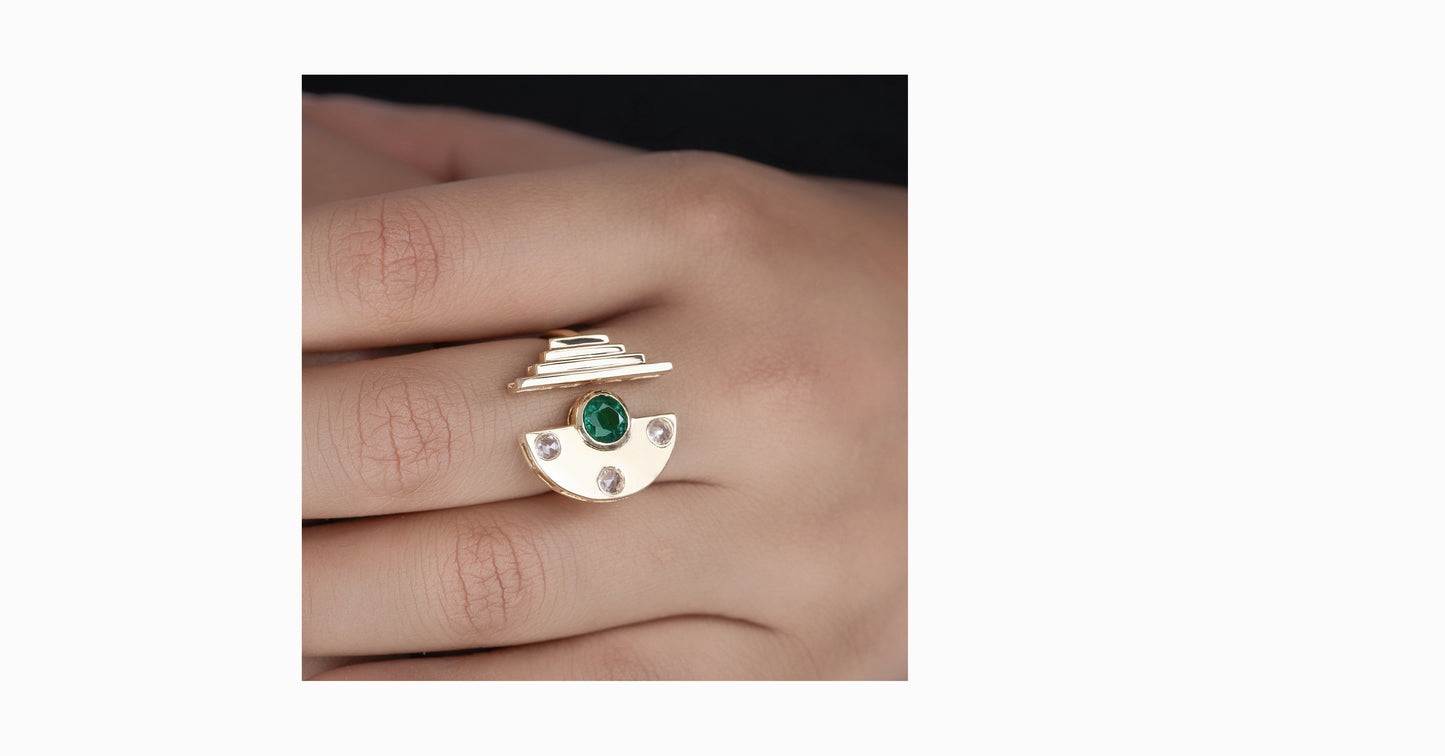 14kt yellow gold ring with round-shaped emerald and bezel diamonds