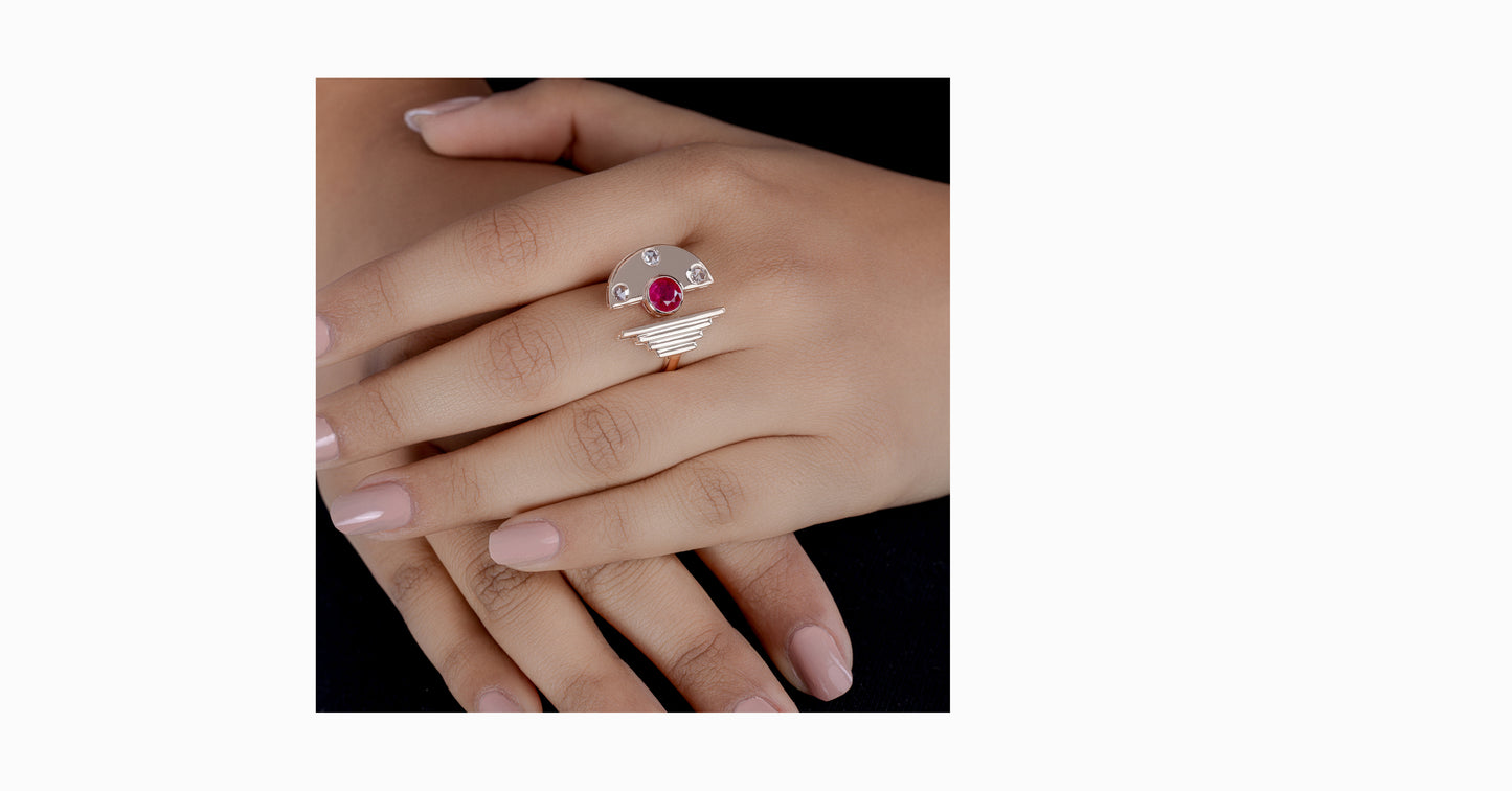 14kt rose gold ring with round-shaped ruby and bezel diamonds
