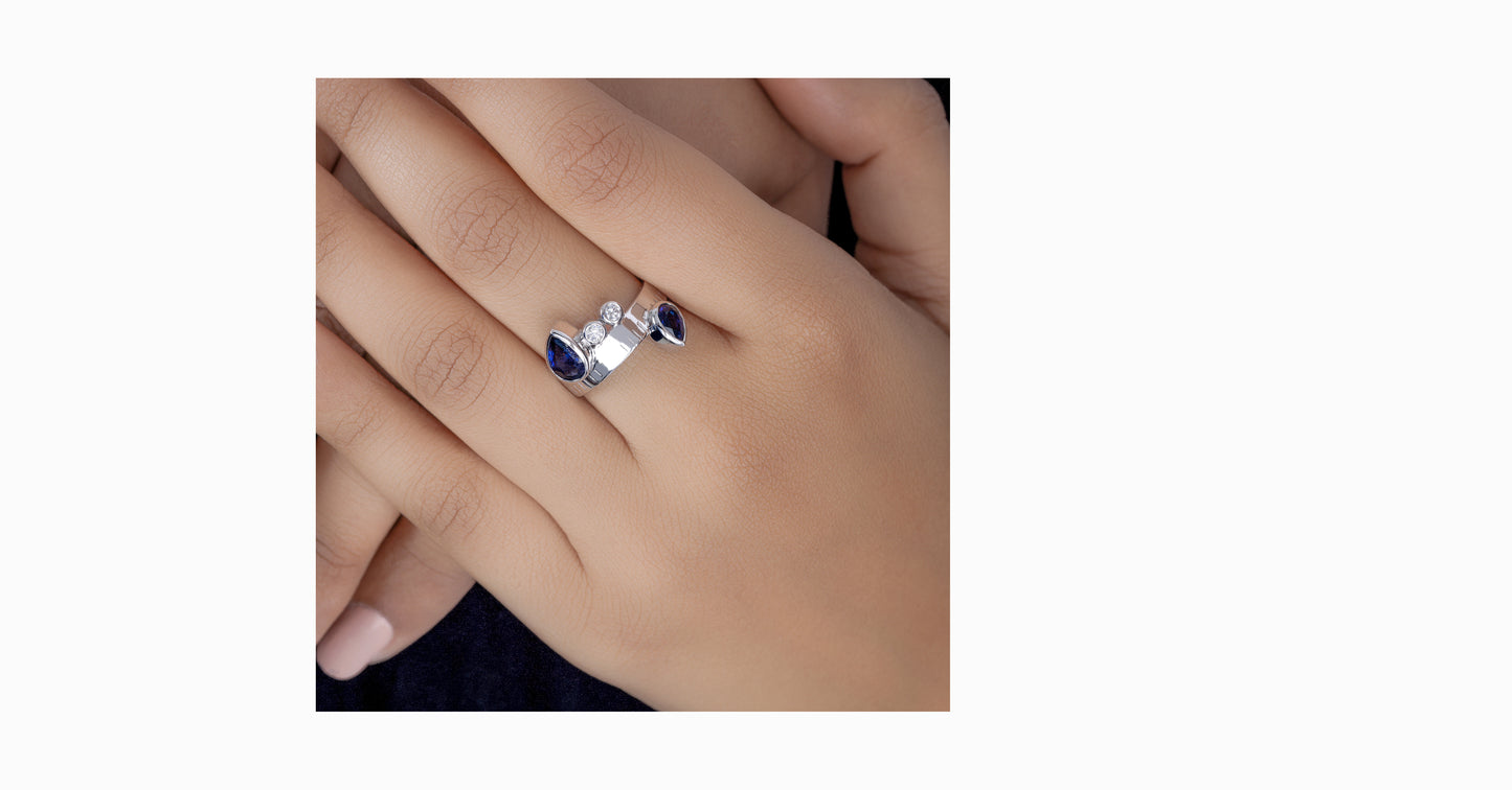 14kt white gold ring with pear-shaped blue sapphire and bezel diamonds