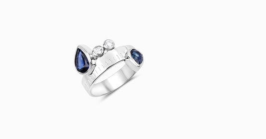 14kt white gold ring with pear-shaped blue sapphire and bezel diamonds
