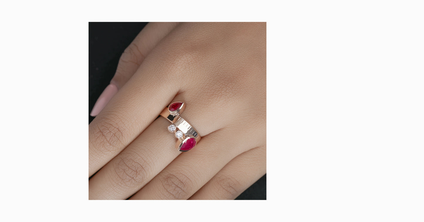 14kt rose gold ring with pear-shaped ruby and bezel diamonds