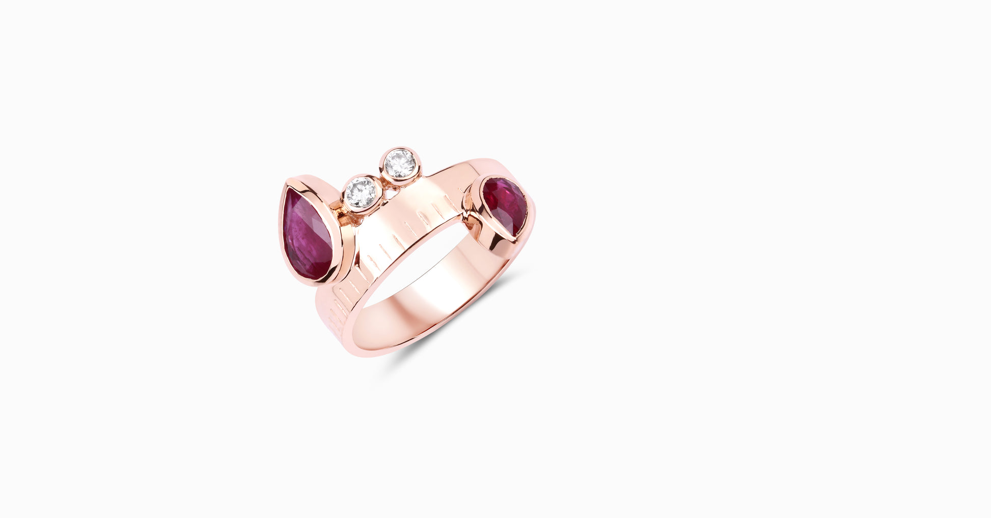 14kt rose gold ring with pear-shaped ruby and bezel diamonds