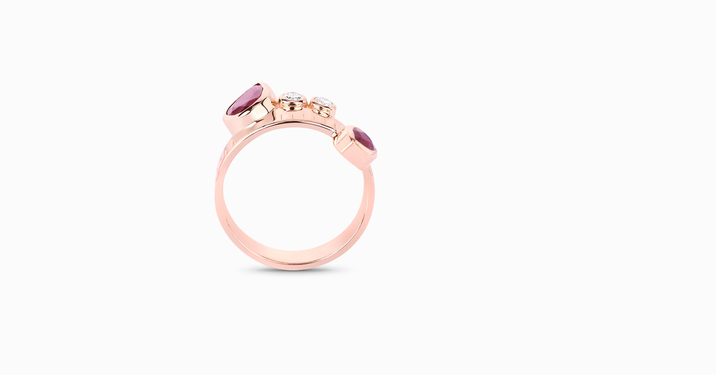 14kt rose gold ring with pear-shaped ruby and bezel diamonds