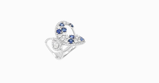 14kt white gold ring with round and pear-shaped diamonds and round-shaped blue sapphire