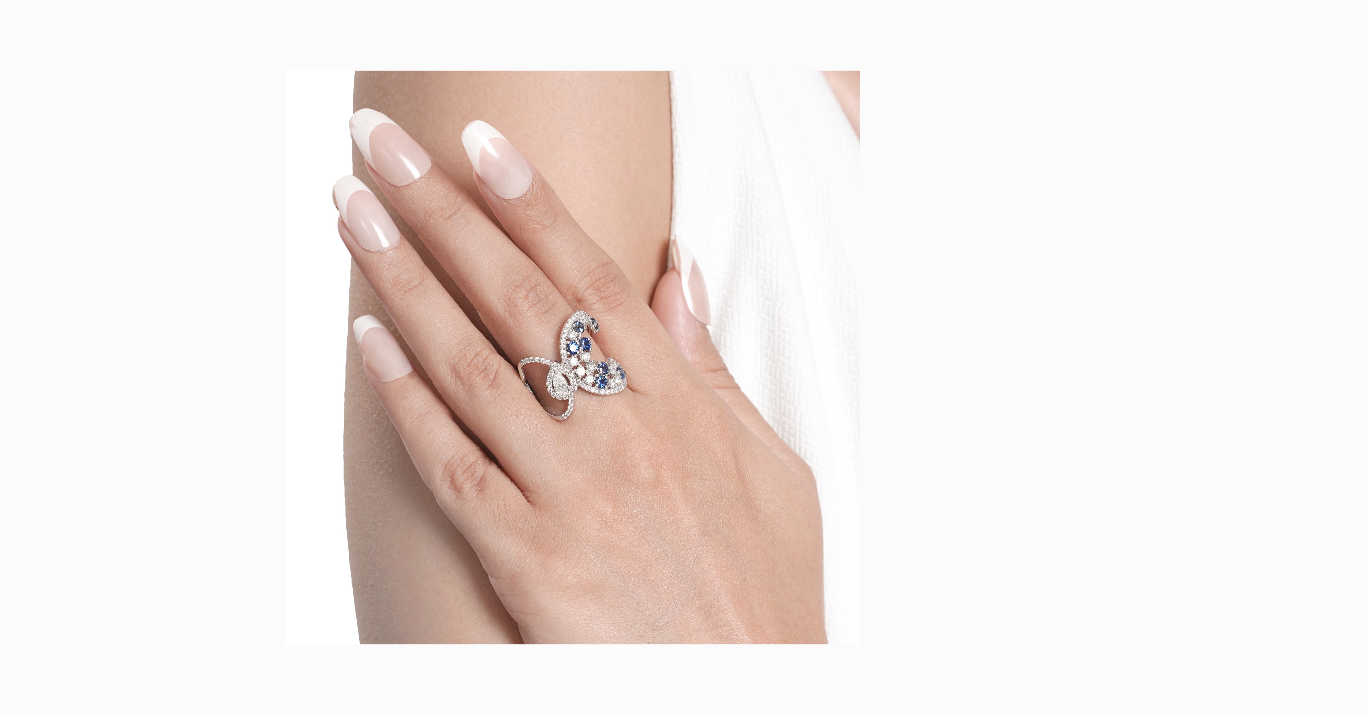 14kt white gold ring with round and pear-shaped diamonds and round-shaped blue sapphire