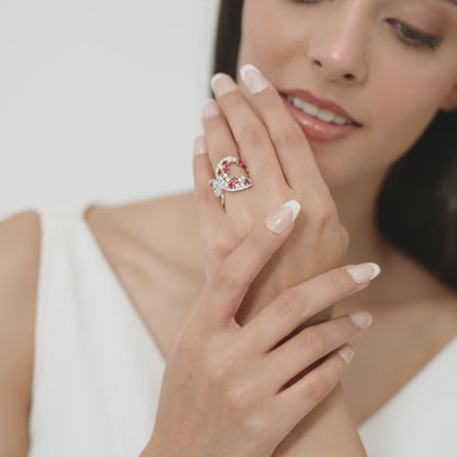 14kt white gold ring with round and pear-shaped diamonds and round-shaped ruby