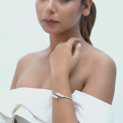 14kt white gold bangle with marquise-shaped sapphire and pave diamonds