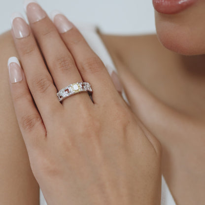 14kt white gold ring with round and baguette-shaped diamonds and cushion-cut natural yellow diamond